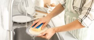 A woman in the kitchen washing the dishes