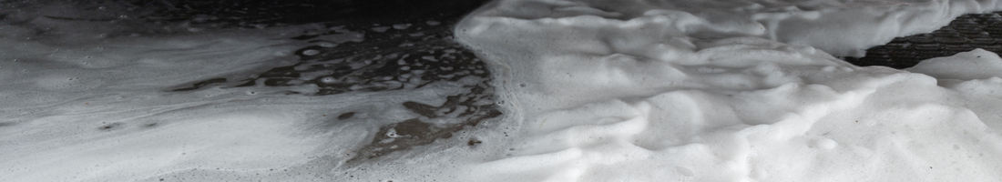 wash soap sud is draining on the floor.