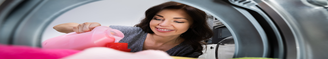 Woman Washing Clothes Using Washer Machine And Laundry Soap
