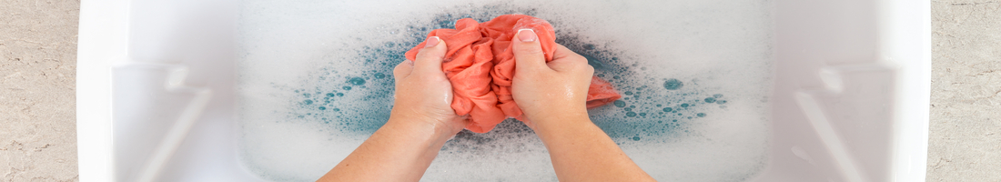 Washing clothes in sink in laundry room