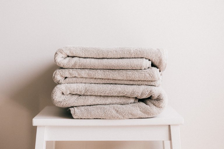 Stack of soft folded towels on a stool