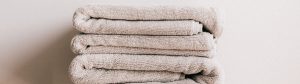 Stack of folded bath towels showing the soft texture fabric softener creates